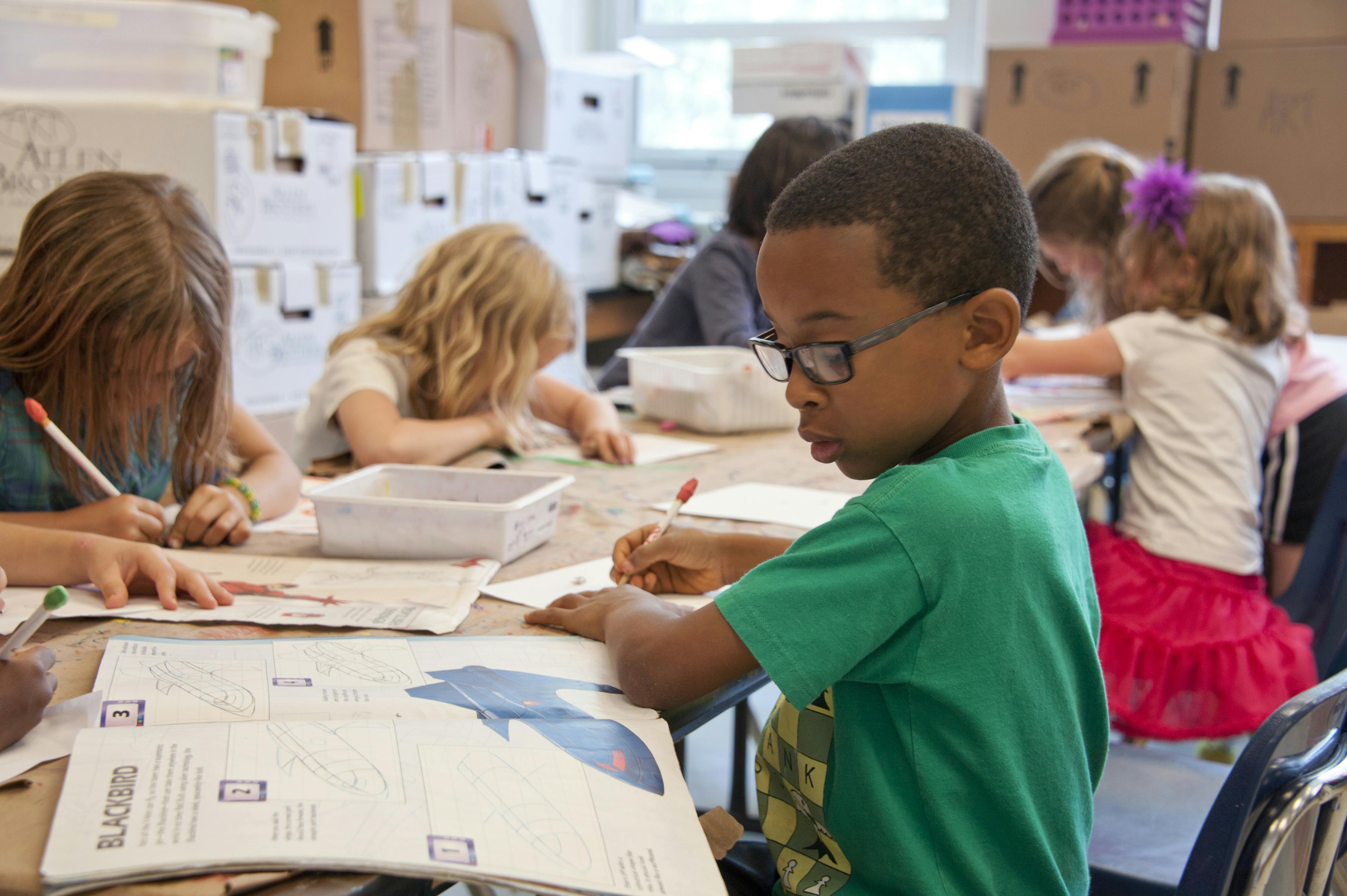 a teacher reading to student who are sitting on the floor